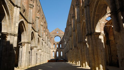 the roofless Abbey of San Galgano under a blue sky