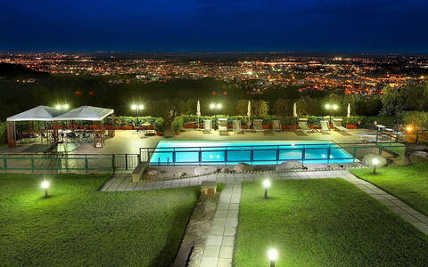 Sughera Villa: Night, Green, Sky, Lighting, Light, Architecture, Sport Venue, Grass, Tree, House