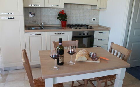 Scarlino Summer Village: Countertop, Room, Property, Furniture, Kitchen, Cabinetry, Floor, Tile, Table, House