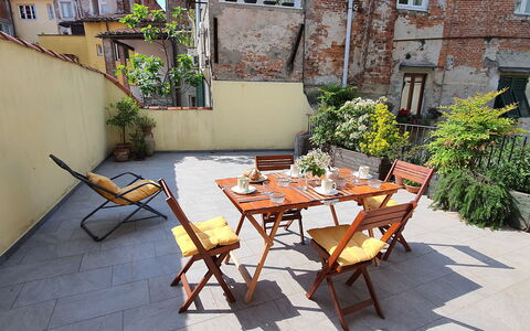 Musetta: Plant, Building, Property, Furniture, Table, Window, Outdoor Table, Chair, Outdoor Furniture, Shade