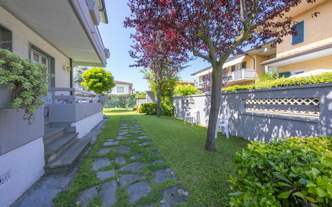 Pontremoli Apartments: Plant, Property, Building, Road Surface, Tree, Vegetation, Urban Design, Grass, Sky, Shade