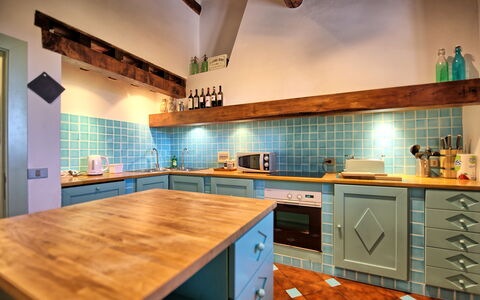 Villa Paneretta: Countertop, Cabinetry, Property, Kitchen, Kitchen Appliance, Kitchen Stove, Wood, Kitchen Sink, Drawer, Lighting