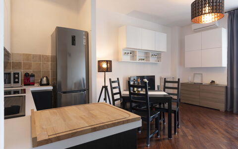 Novoli Suite Apartment: Furniture, Table, Cabinetry, Wood, Kitchen, Flooring, Interior Design, Drawer, Floor, Chair