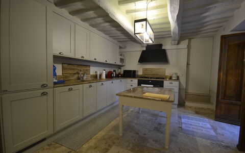 Villa Torreone: Cabinetry, Wood, Kitchen, Flooring, Floor, House, Countertop, Building, Hardwood, Door