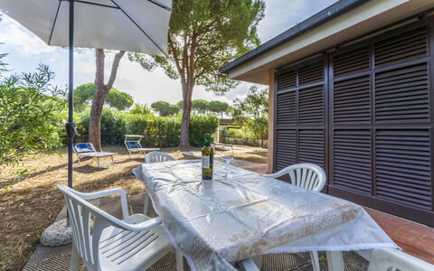 Giannella Apartment - Orbetello, Toscana: Furniture, Plant, Property, Table, Chair, Shade, Building, Outdoor Furniture, Tree, Sky