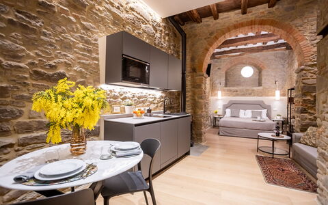 Maccari Suite: Interior Design, Furniture, Flooring, Living Room, Ceiling, Stone Wall, Couch, Chair, Light Fixture