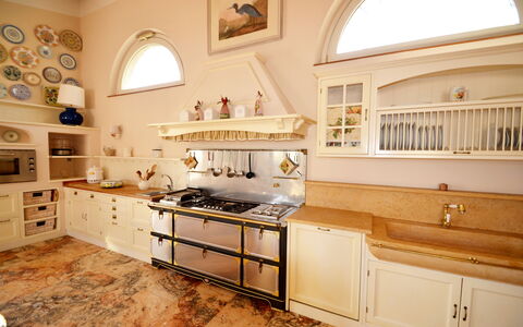 Villa Yvonne: Kitchen, Interior Design, Countertop, Wood, Furniture, Cabinetry, Flooring, Kitchen Appliance, Kitchen Stove, Lighting