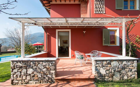 Villa Camaiore: Chair, Balcony, Shade, Porch, Awning, Houseplant, Paint, Outdoor Structure, Hacienda, Villa
