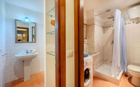 The Silent Courtyard Retreat: Spacious 2-Bedroom S: Flooring, Floor, Plumbing Fixture, Bathroom, Interior Design, Wood, Bathroom Sink, Ceiling, Sink, Room