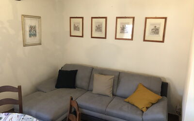 Appartamento Enotria: Furniture, Couch, Flooring, Interior Design, Floor, Wood, Living Room, Room, Table, Home