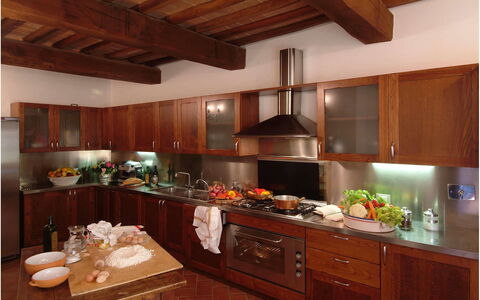 Villa Montichiello: Kitchen, Countertop, Cabinetry, Wood, Kitchen Appliance, Interior Design, Furniture, Major Appliance, Light Fixture, Lighting