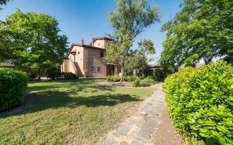 Casale dei Girasoli 14: Shrub, House, Residential Area, Home, Garden, Estate, Lawn, Landscaping, Suburb, Yard