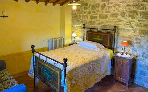 Torre di Vignale: Wall, Furniture, Bedroom, Bed Frame, Bed, Villa, Stone Wall, Picture Frame, Bedding, Houseplant