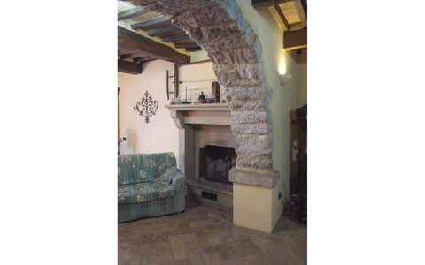 Casa la Primula: Wall, Stone Wall, Natural Material, Living Room, Hearth, Brick, Fireplace, Houseplant, Hardwood, Tile