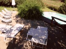 Solarium near the pool with garden furnitures and sunbeds